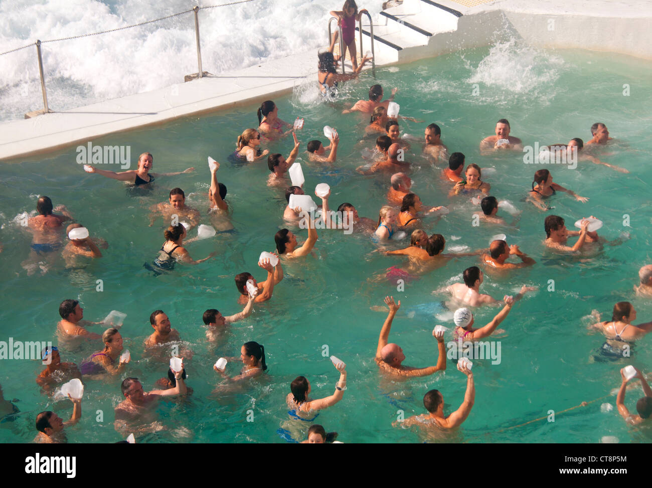 Bondi Icebergs swimmers in pool holding blocks of ice aloft on first ...