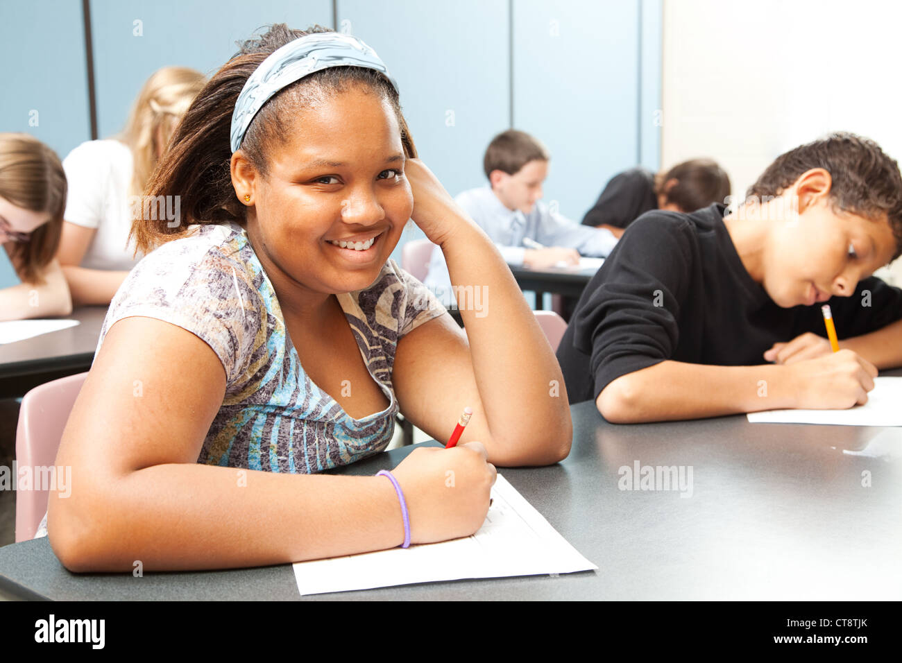 Pretty African-American girl in diverse middle school class.  Stock Photo