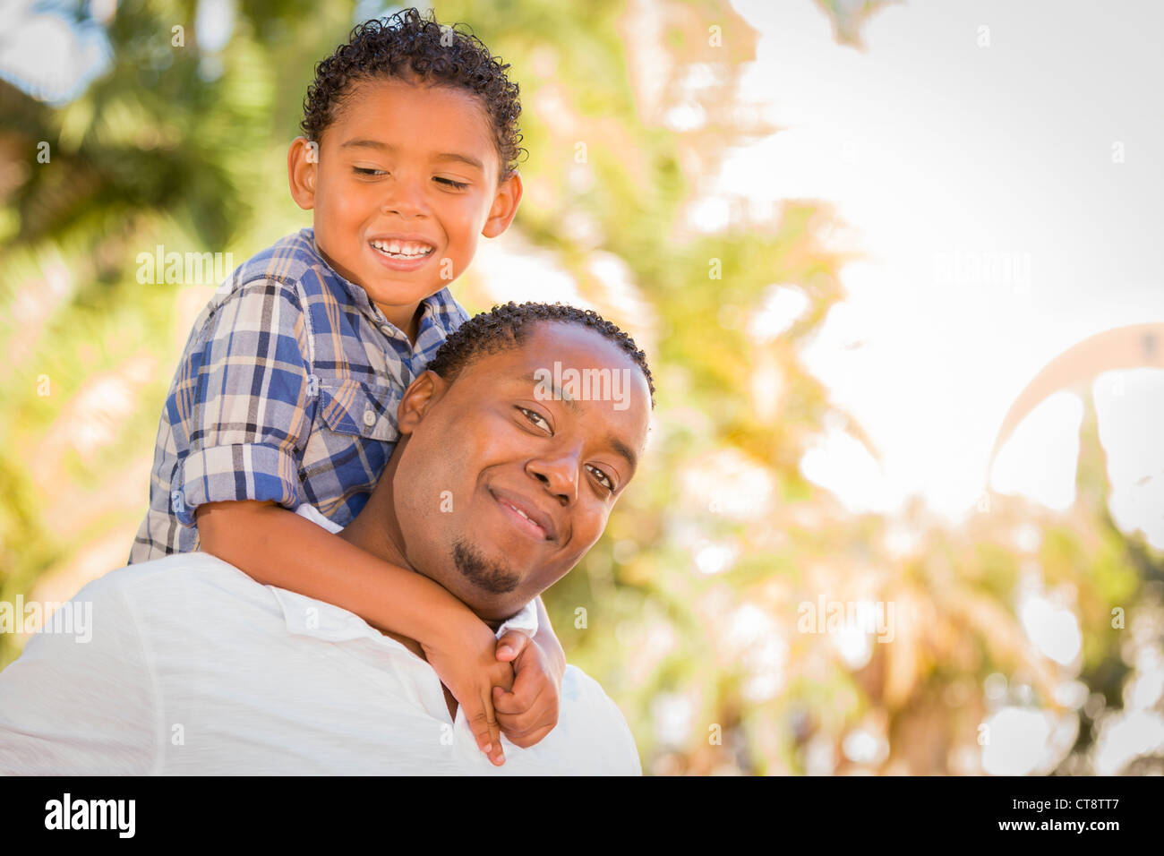Happy African American Father and Mixed Race Son Playing Piggyback in ...
