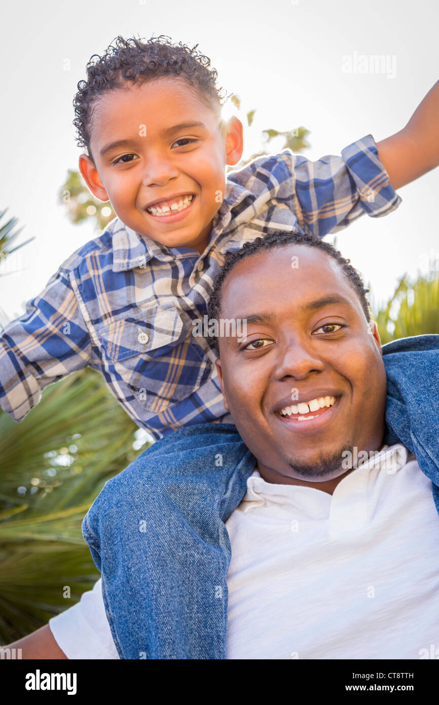 Happy African American Father and Mixed Race Son Playing Piggyback in ...