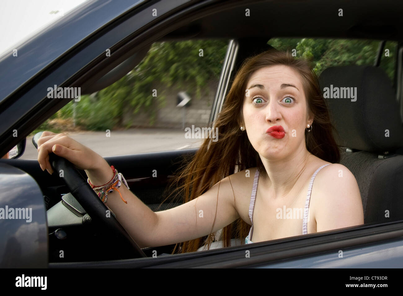 Woman in the car that makes faces Stock Photo Alamy