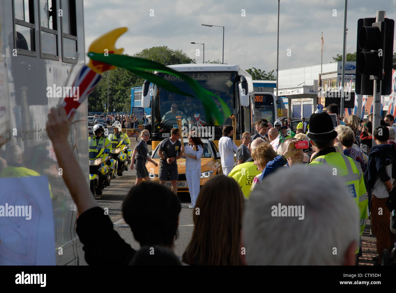 Changeover of Torchbearers in the Olympic Torch Relay on Penistone Road, Sheffield, England, UK Stock Photo