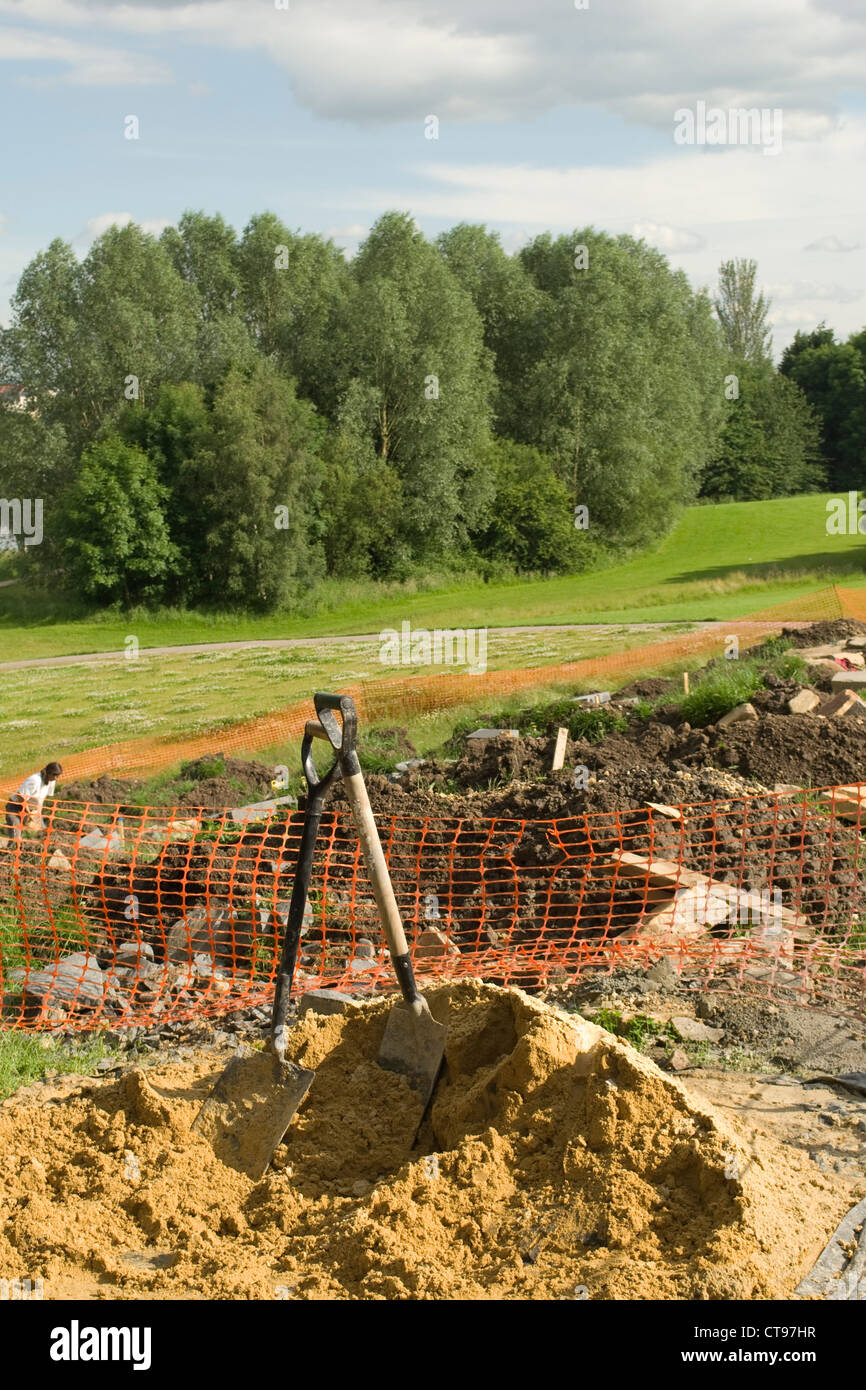Shovels in building sand on a building site Stock Photo