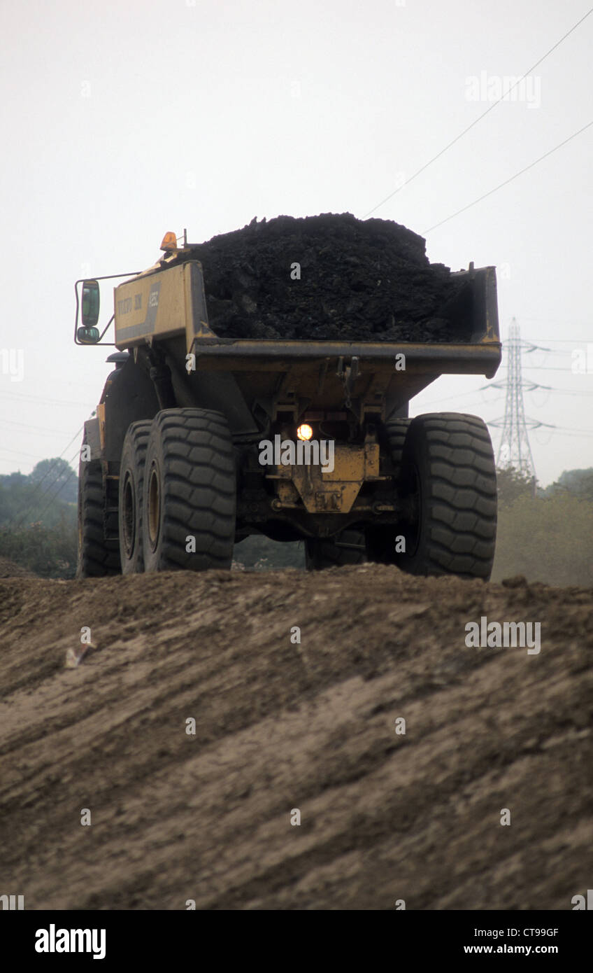An Articulated Volvo BM-A25C Dumper Truck transporting top-soil along a new bridal-way for horse riders in Northern England. Stock Photo