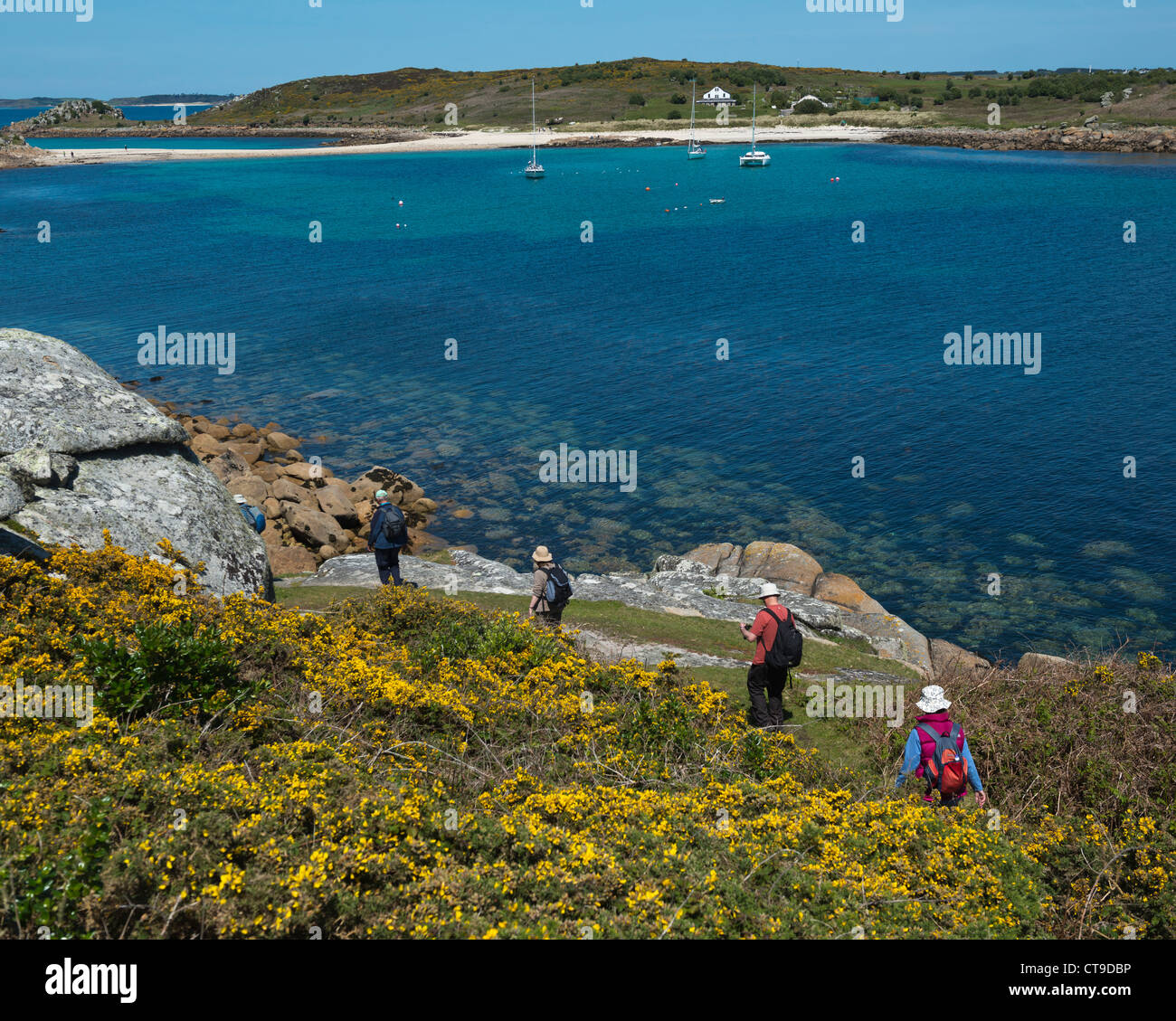 Small group of ramblers on the coastal path at St Agnes. The Isles of Scilly Stock Photo