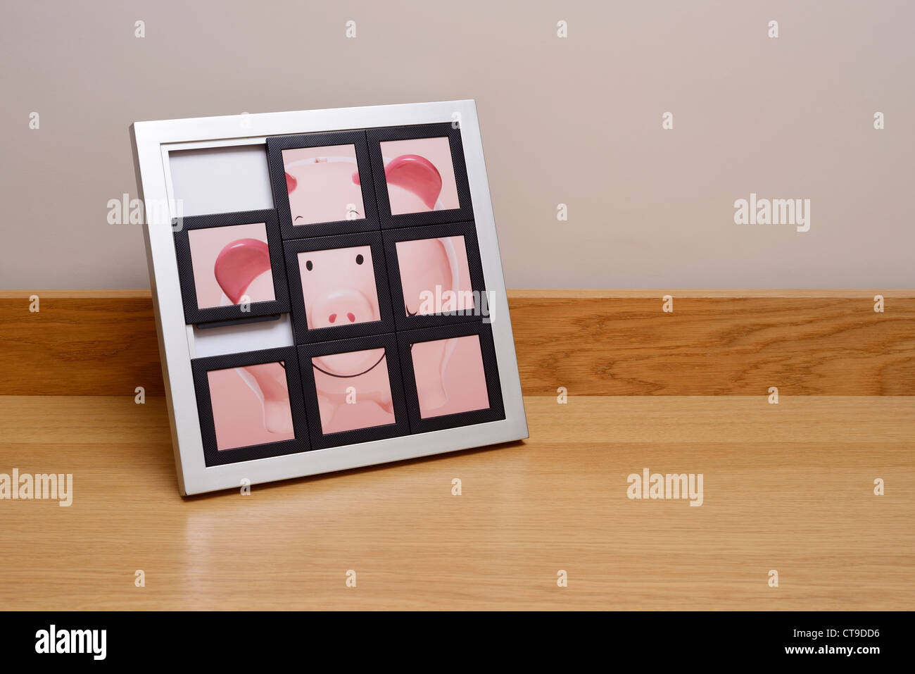 Piggy bank in a slide picture frame Stock Photo