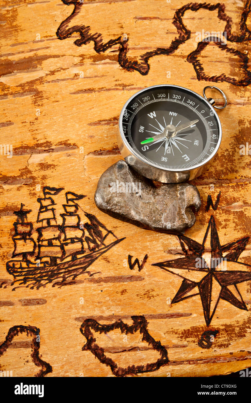 Compass and ingot of silver on sea map on the order of olden time Stock Photo