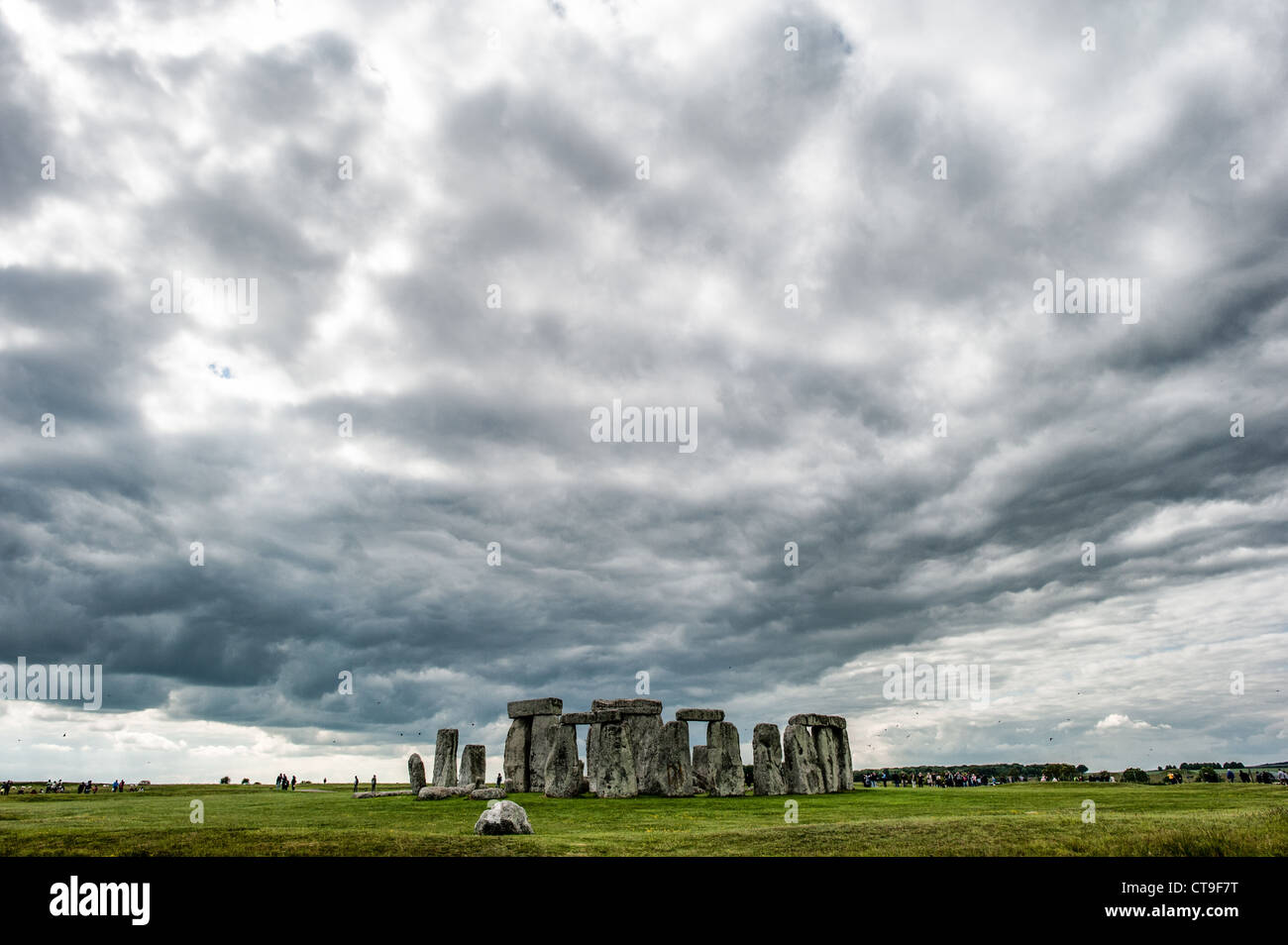 STONEHENGE, UK - LONDON, UK - Stonehenge with Threatening Skies. Believed to have been built somewhere between 2000 and 3000 BC, Stonehenge is one of the United Kingdom's most distinctive landmarks. It's function and purpose remains a matter of conjecture, although many theories have been offered. It consists of a series of large standing stones, some of which have toppled over the centuries. Stonehenge is located in Salisbury Plain west of London. Stock Photo