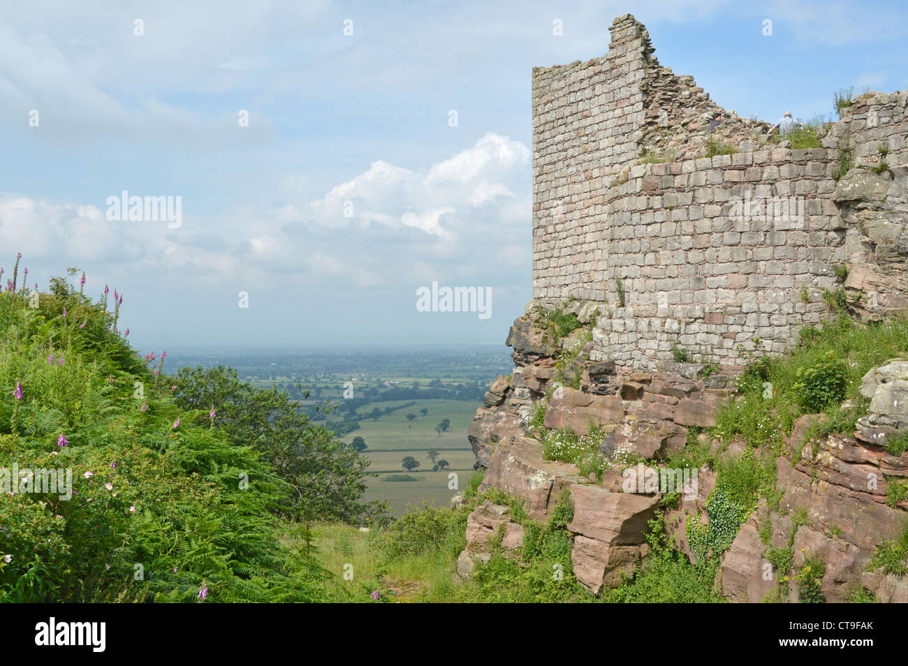 Sandstone rock foundation & part of ruins of inner ward of Beeston Castle at summit of 500ft high crag with views across  UK Cheshire Plain farmland Stock Photo