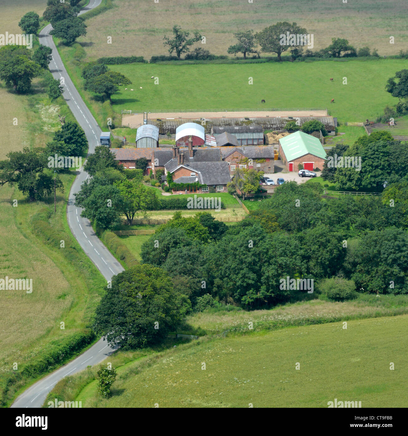 Aerial view of agriculture from above looking down on farm buildings & farmhouse with adjacent countryside farmland on the fertile Cheshire Plains UK Stock Photo