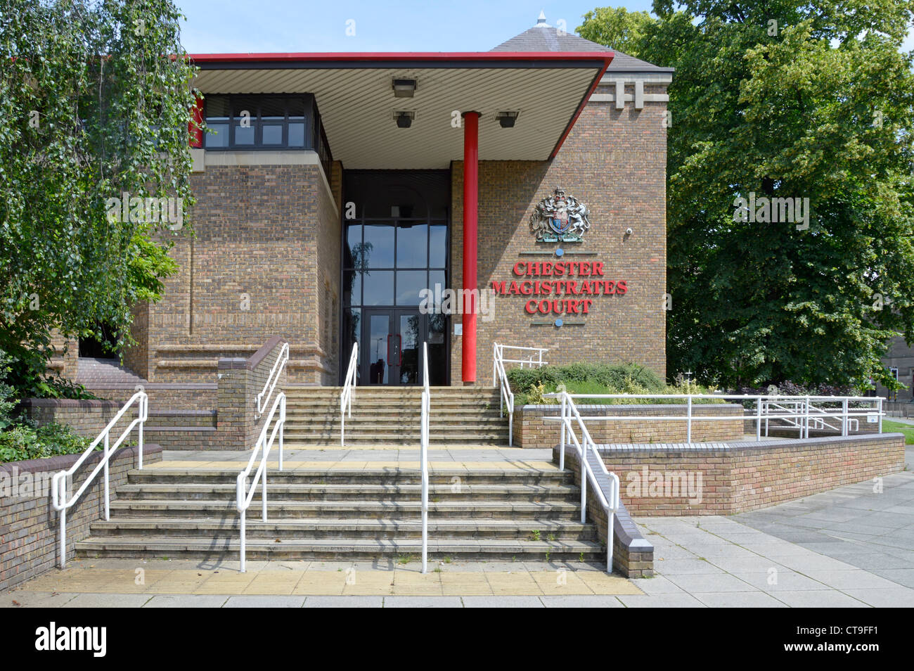 Steps up to Chester Magistrates Court courthouse brick building with canopy above public entrance with royal coat of arms & sign Cheshire England UK Stock Photo