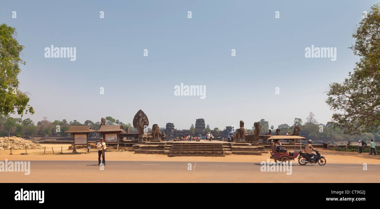 Tourists visiting Angkor Wat at the very first entrance area to the causeway. Stock Photo