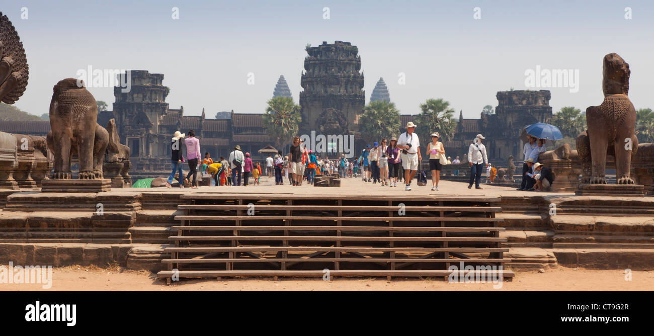 Tourists visiting Angkor Wat at the very first entrance area to the causeway. Stock Photo