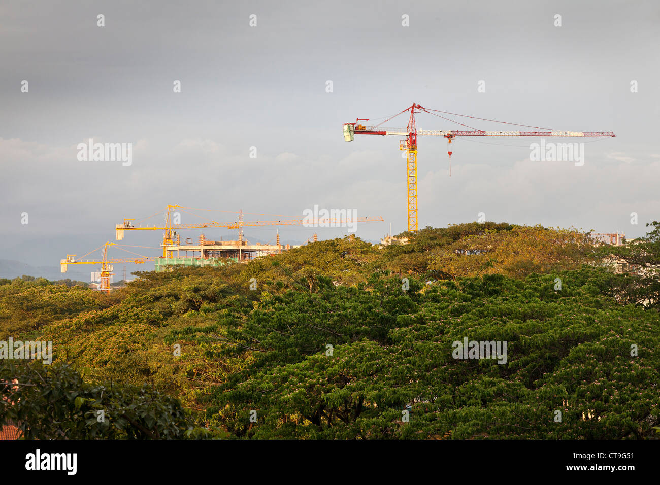 Tower cranes constructing new condominium apartments, Sri Damansara, Kuala Lumpur, Malaysia Stock Photo