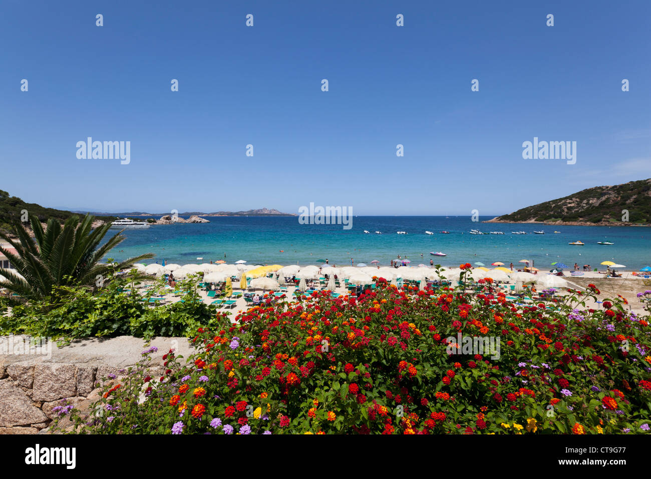 Beach promenade of Baja Sardinia with blooming flowers on Sardinia