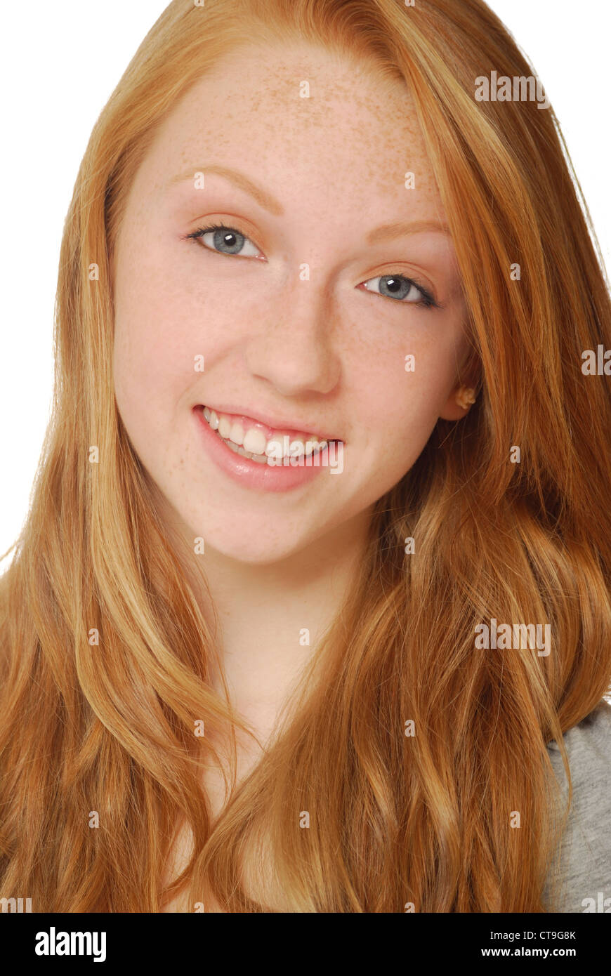 Smiling face of pretty, red haired teenage girl with freckles. Stock Photo