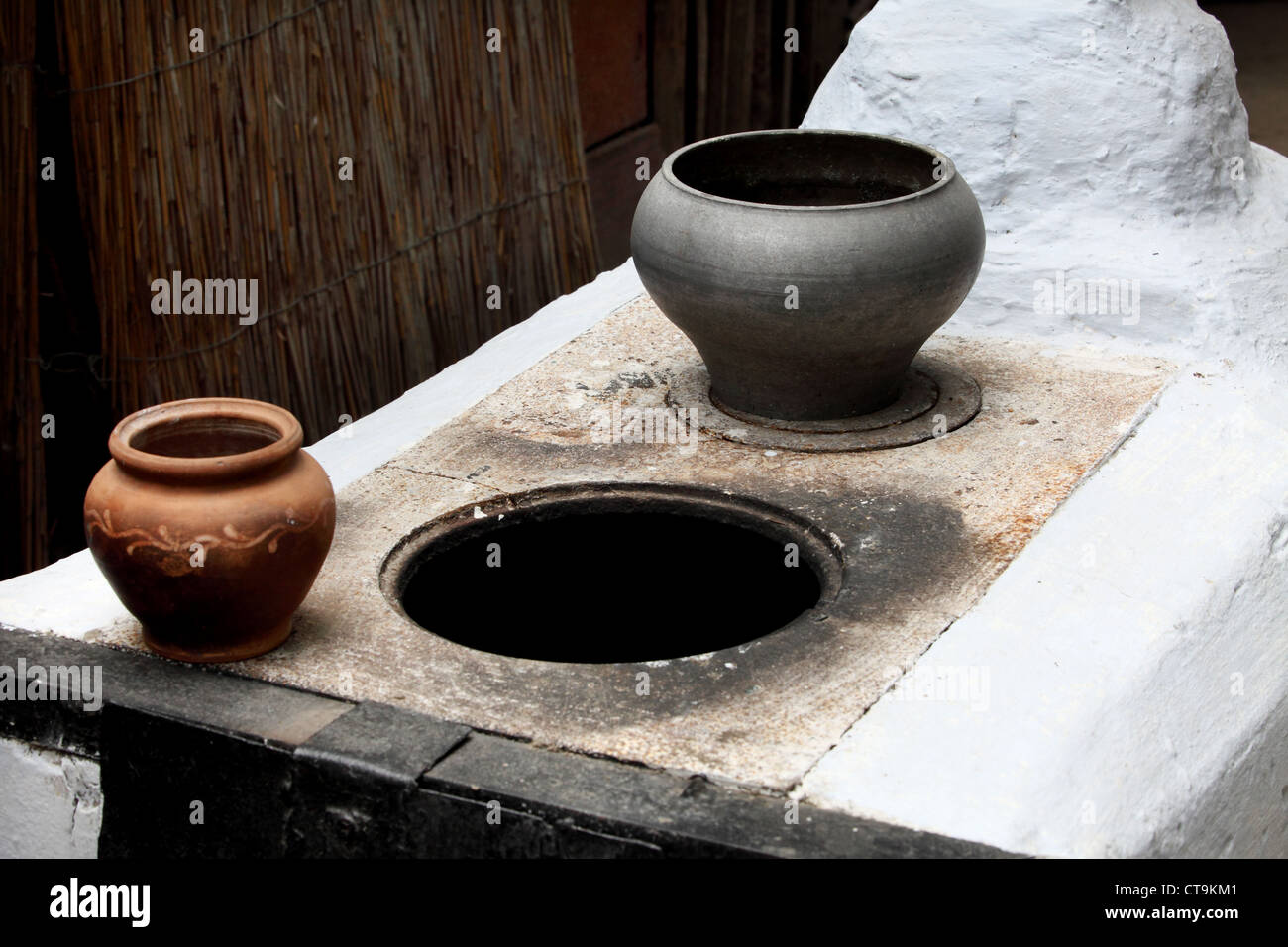 old Russian stove and a metal pot for cooking in the oven Stock Photo