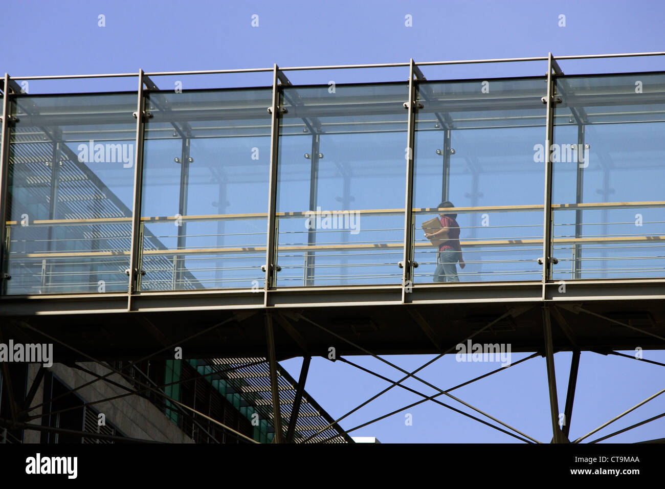 A woman in the glass transition between two buildings Stock Photo Alamy