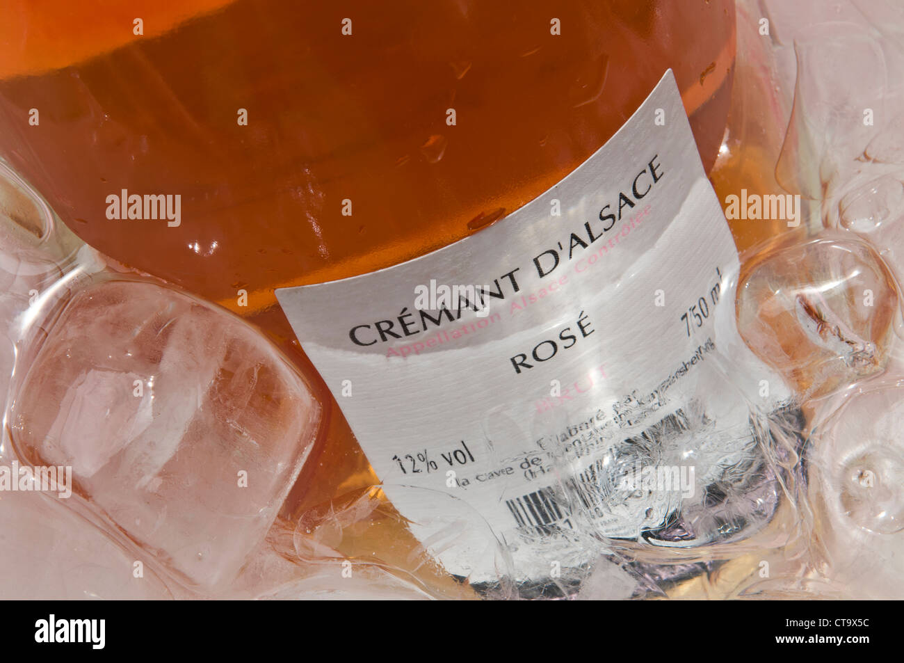 Close view on 'Cremant d'Alsace ' sparkling rose wine bottle label in ice cooler Stock Photo