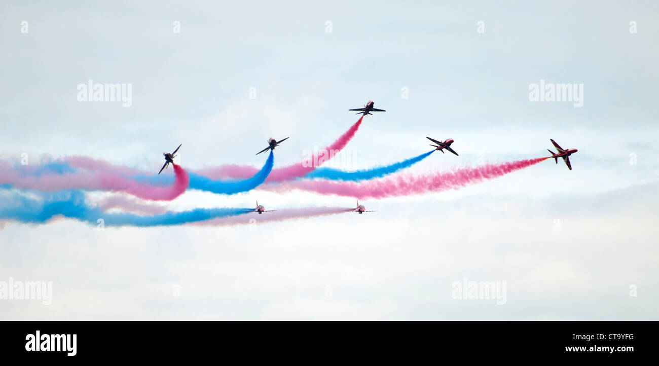 RAF Red Arrows display team trailing red, white and blue smoke Stock Photo