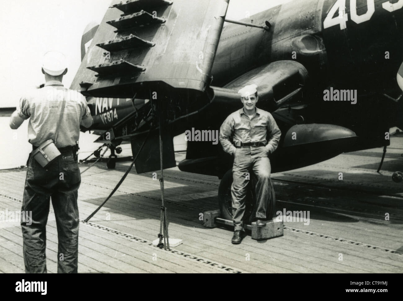 Korean War standing next to flighter plane of VF-874 Fighter Squadron Stock Photo
