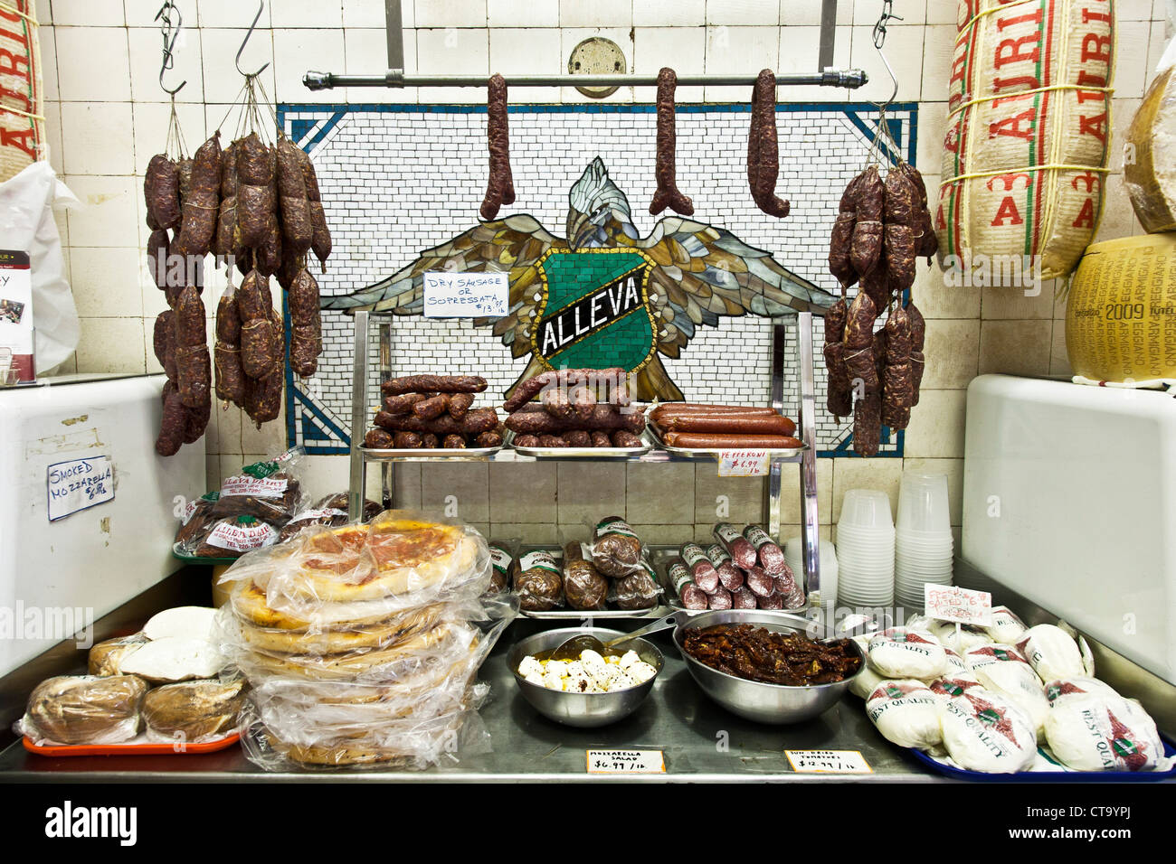 Italian sausages salamis & cheese displayed against original tile mural in Alleva, the oldest Italian cheese store in America Stock Photo