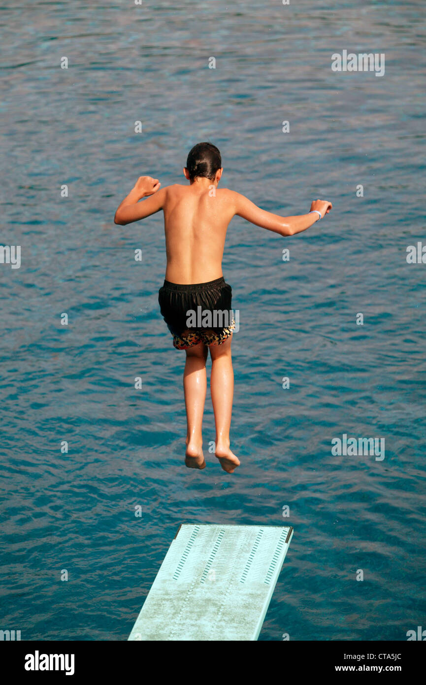 Berlin, boy jumps off the diving board into the water Stock Photo Alamy