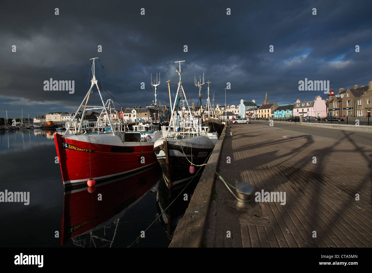 Town of Stornoway, Lewis. Picturesque evening view of the fishing fleet alongside Stornoway Harbour. Stock Photo