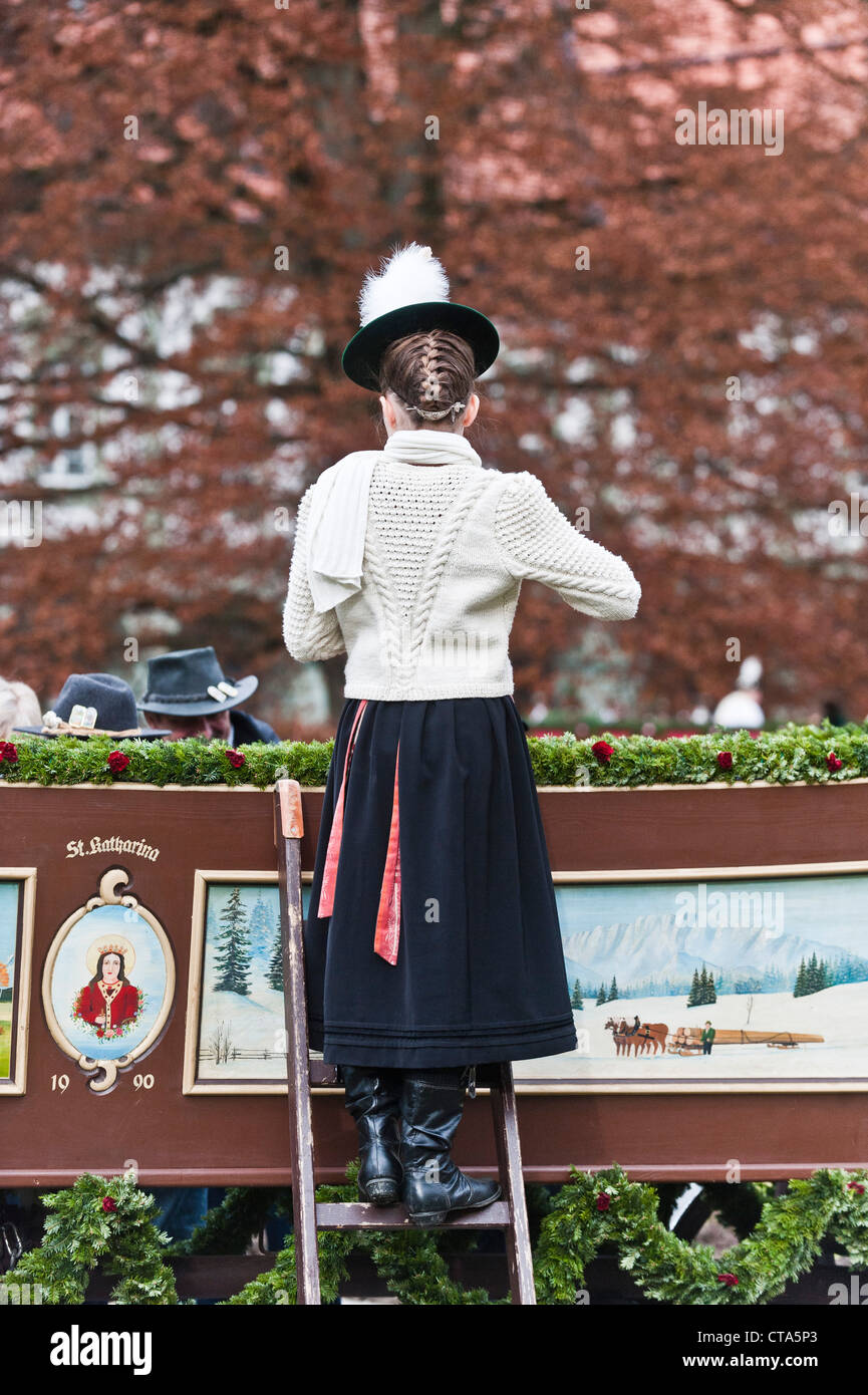 Girl on a ladder wearing traditional costumes, festival of