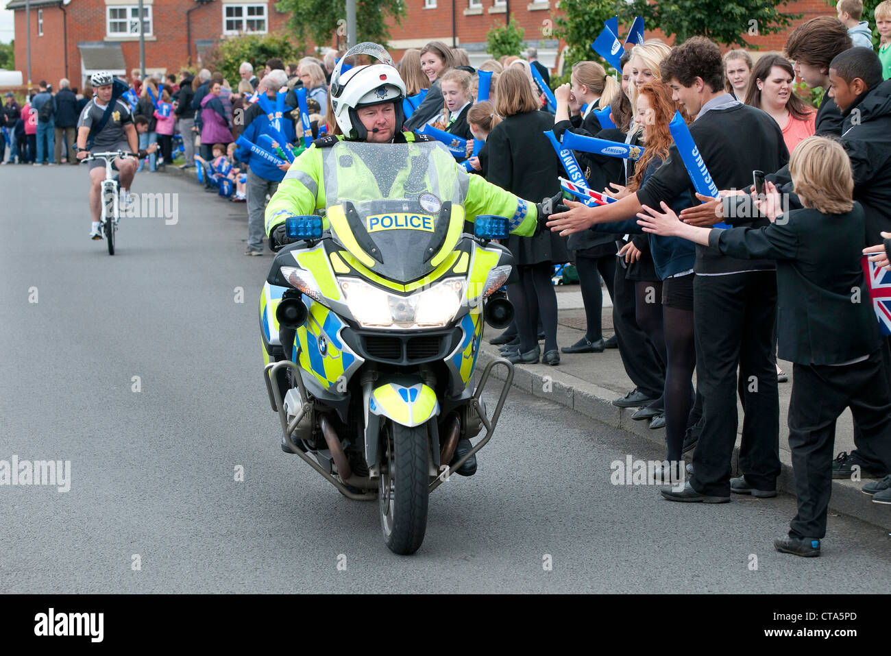 police motorcyclist outrider greeting school children, stoke mandeville, buckinghamshire, england Stock Photo