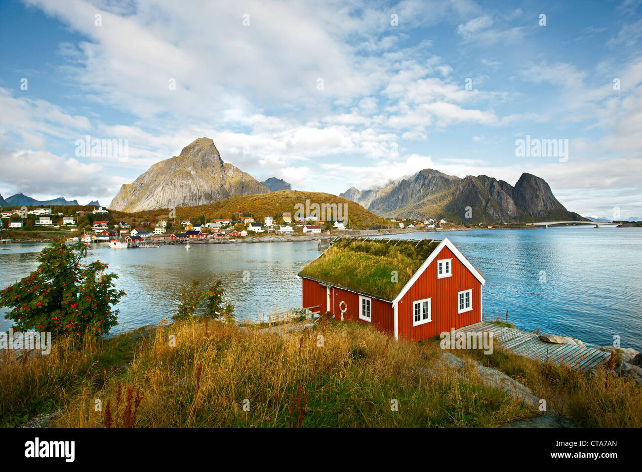 Red wooden house at Reine, view towards the sea, landscape on the Lofoten in Autumn, Moskenesoy, Nordland, Norway, Scandinavia, Stock Photo