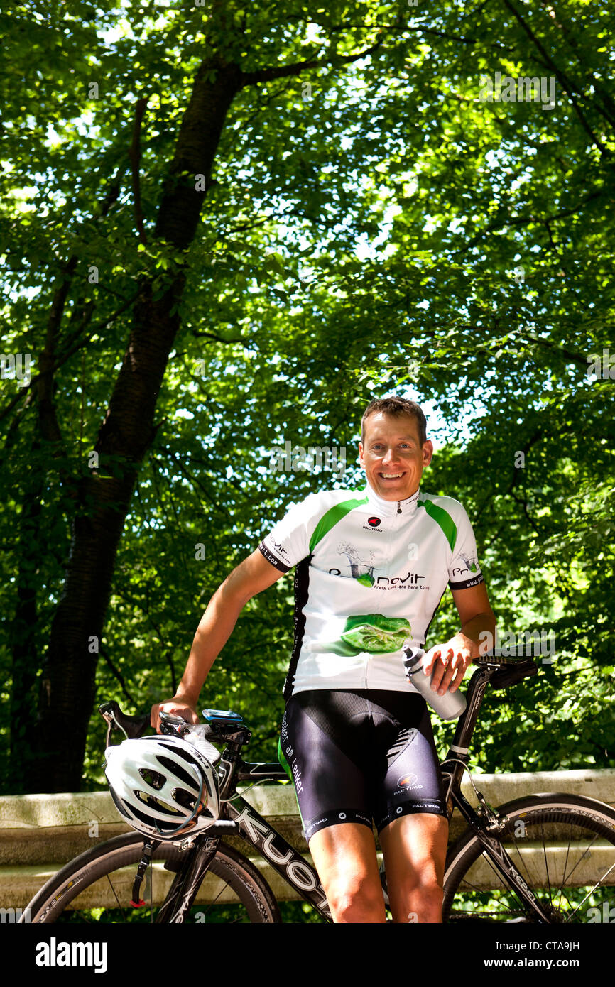 Bicycle racer leaning against guardrail, Bergisches Land, North Rhine-Westphalia, Germany Stock Photo