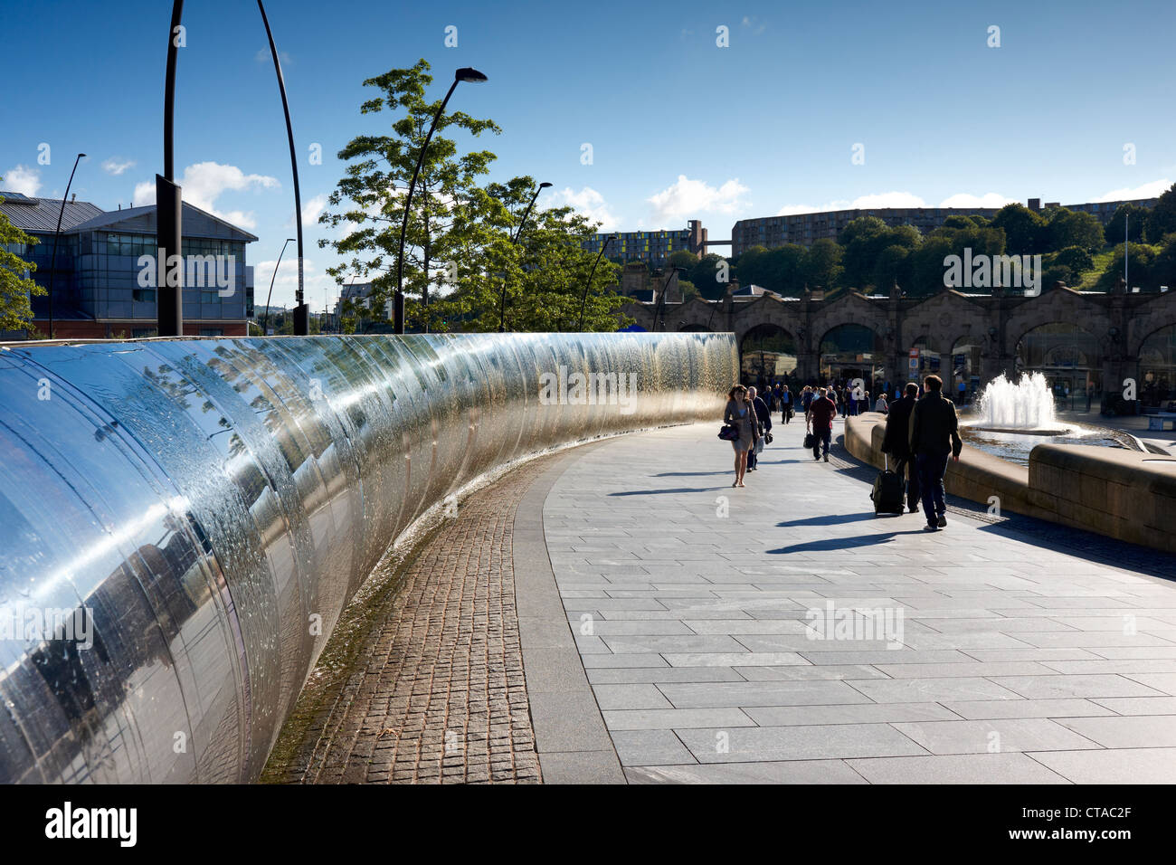 Commuters at Sheffield railway station walk past the Cutting Edge sculpture in Sheaf Square Stock Photo