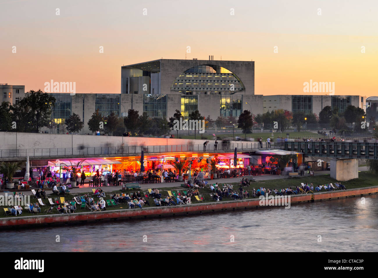 Capital beach cafe at the banks of river Spree, new federal chancellery at dusk, Berlin, Germany, Europe Stock Photo