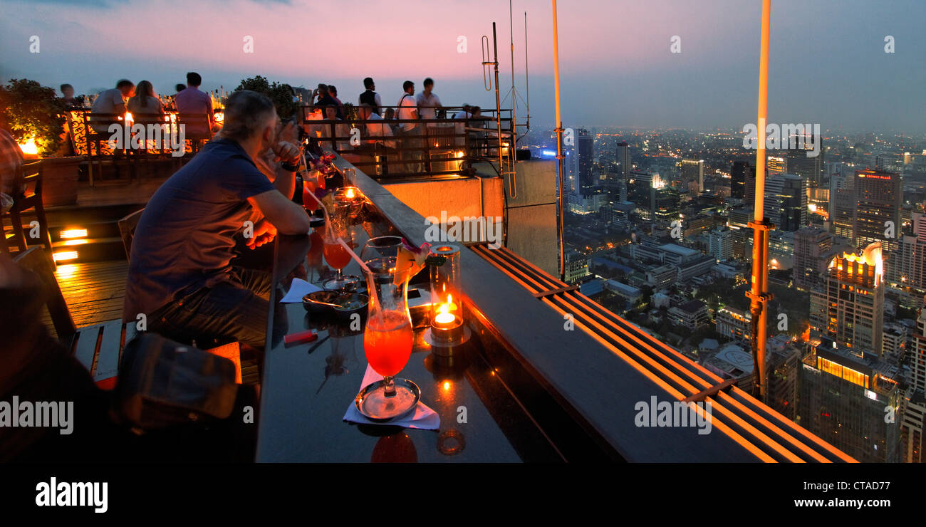 People at roof terrace of Banyan Tree hotel in the evening, Vertigo Bar ...