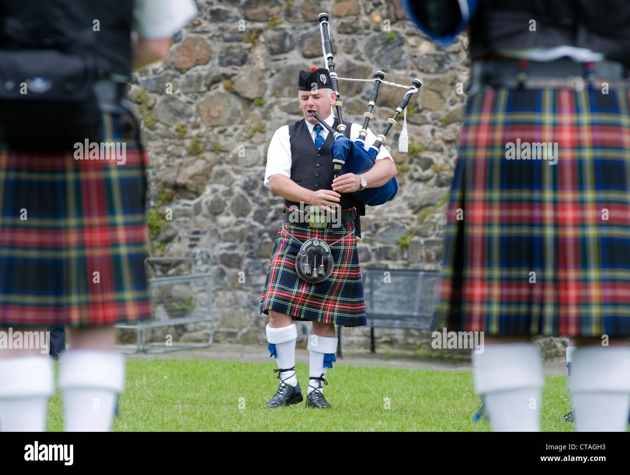Piper of the Sinclair Memorial Pipe Band on Gallows Green, Carrickfergus. Stock Photo