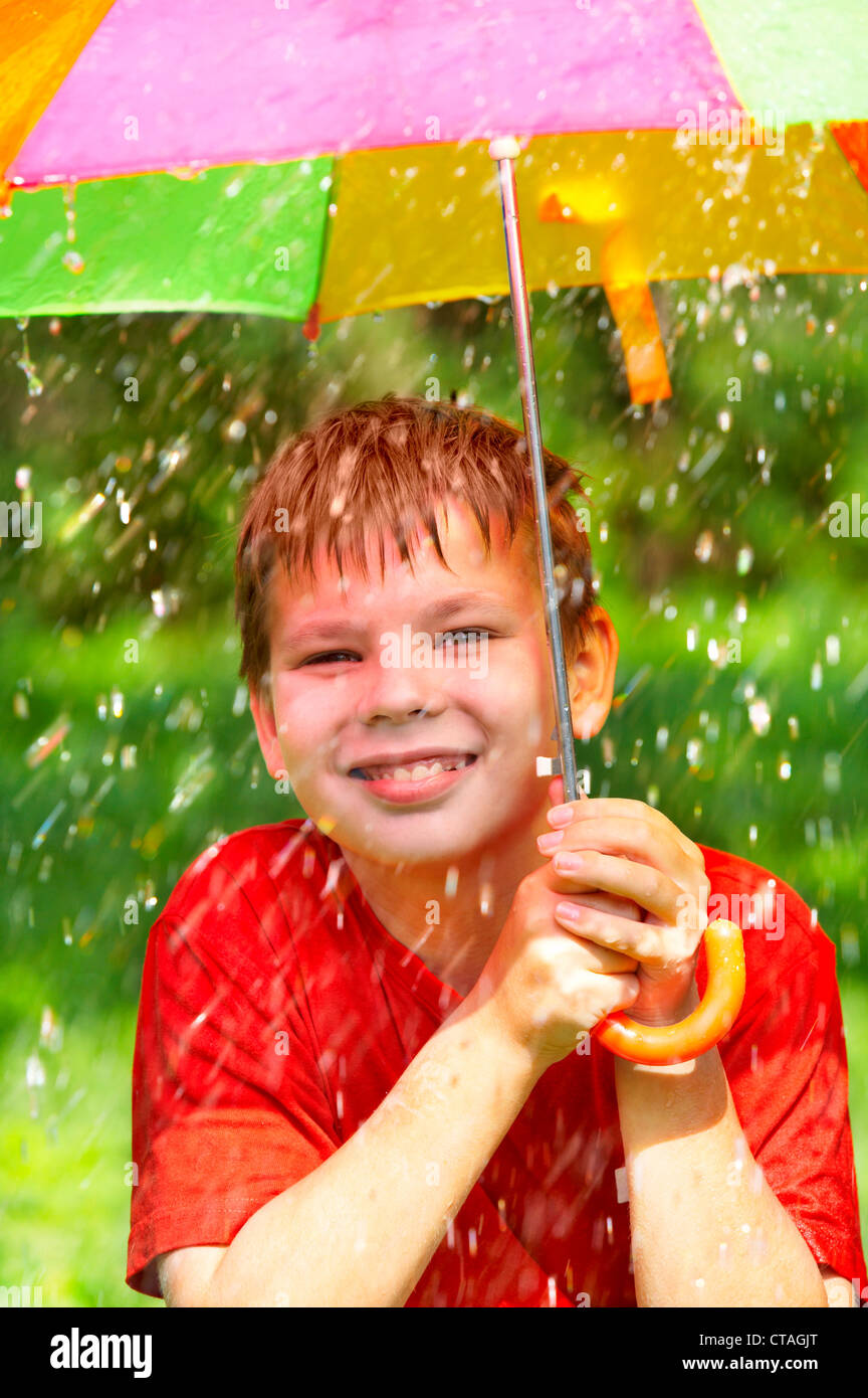boy under an umbrella during a rain Stock Photo Alamy