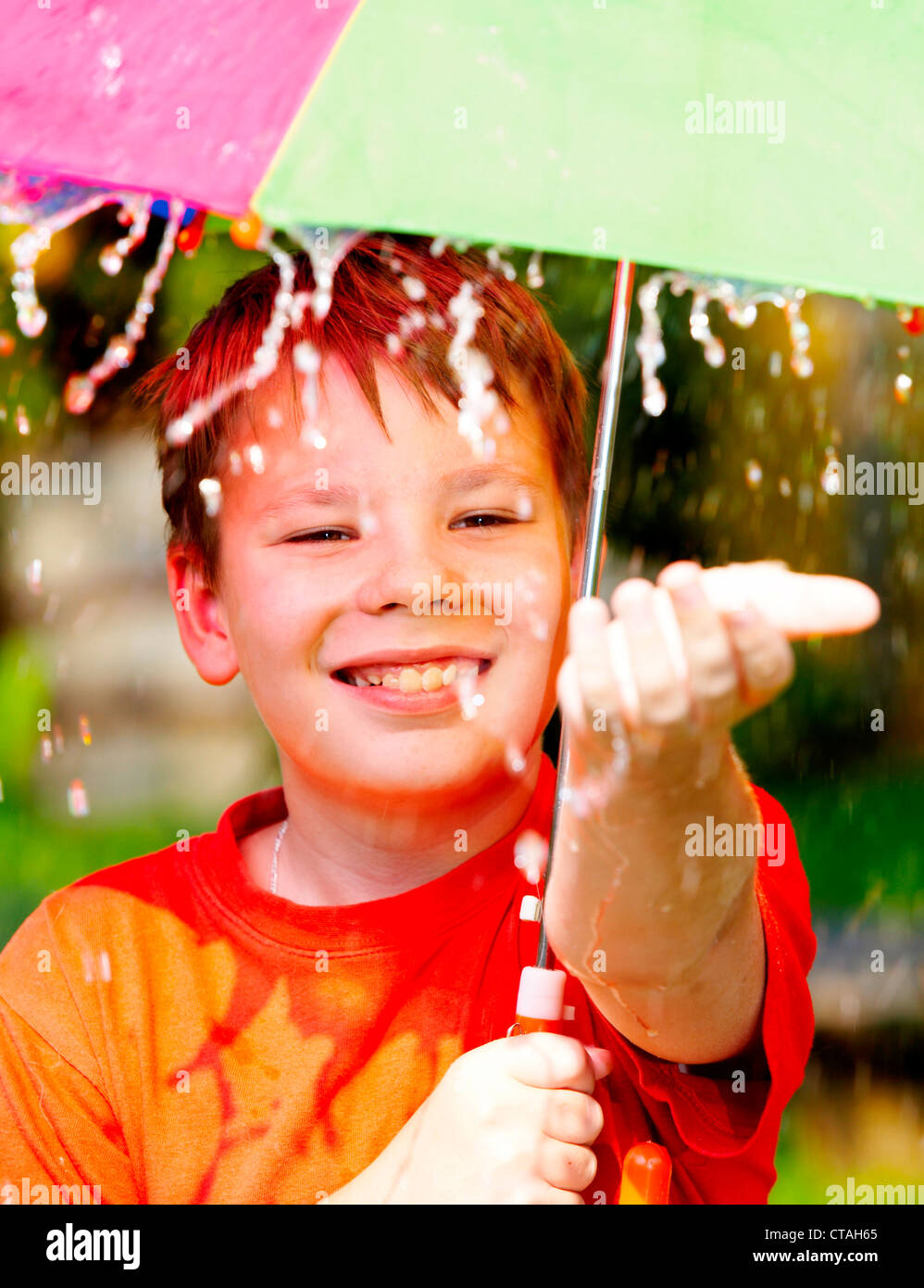 boy under an umbrella during a rain Stock Photo Alamy