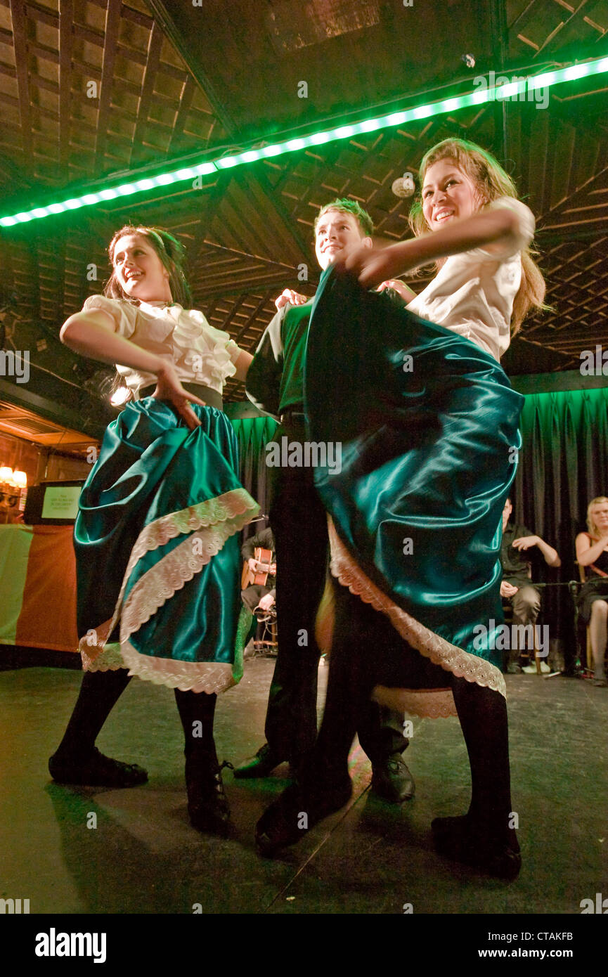 Members of the 'Celtic Rhythm Professional Irish Dancers' on stage with backing music by 'Puca' at the Arlington Hotel, Dublin. Stock Photo