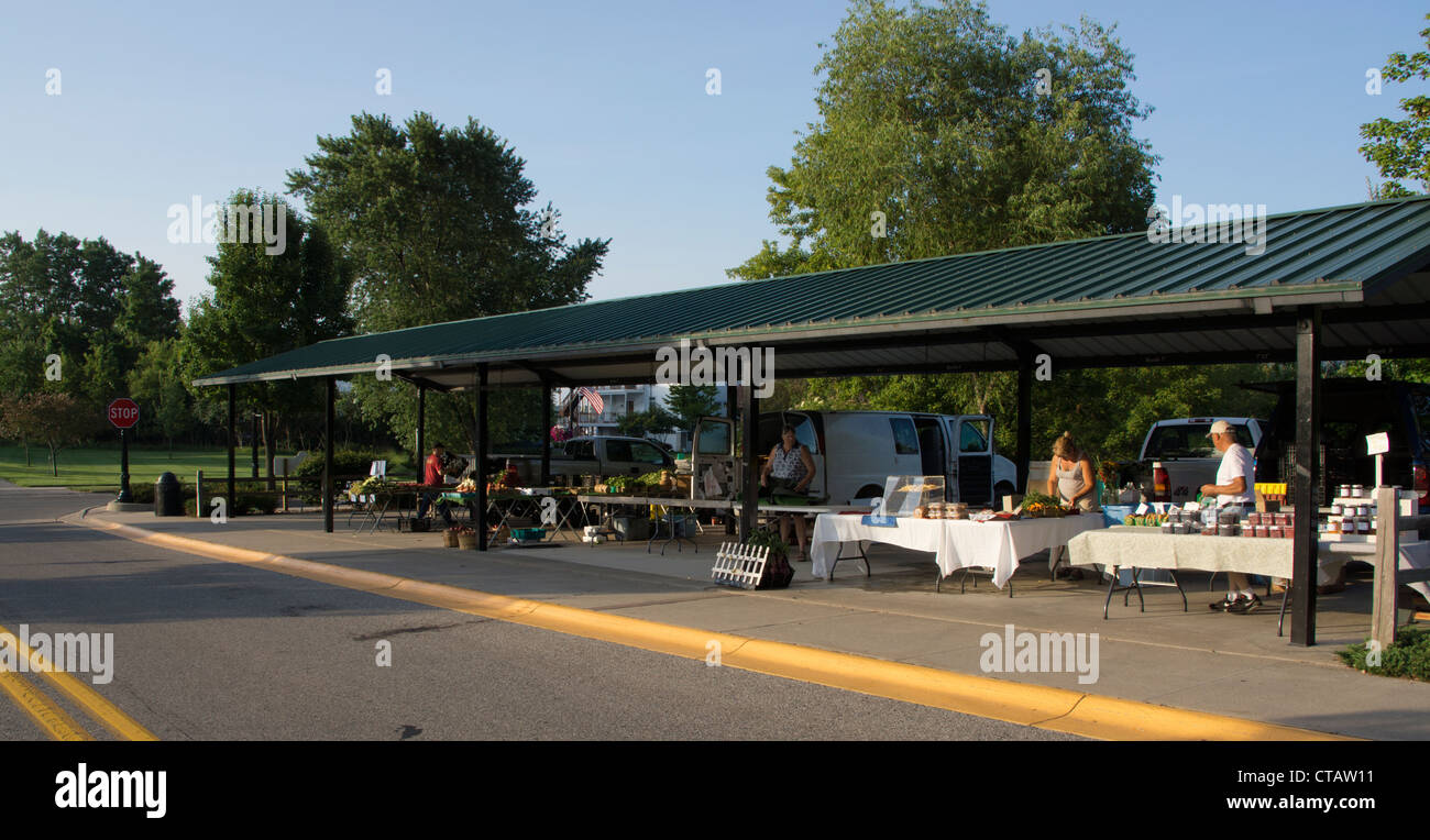 Farmers and local merchants set up their goods in the early morning at the municipal Farm Market