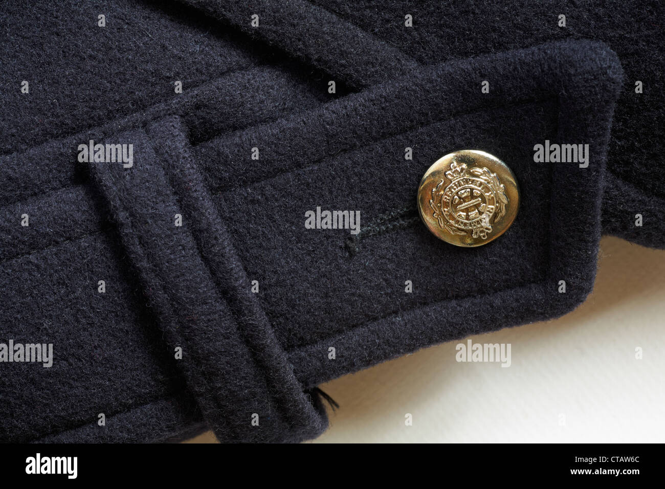decorative gold coloured regiment button on Beechers Brook black woolen coat Stock Photo
