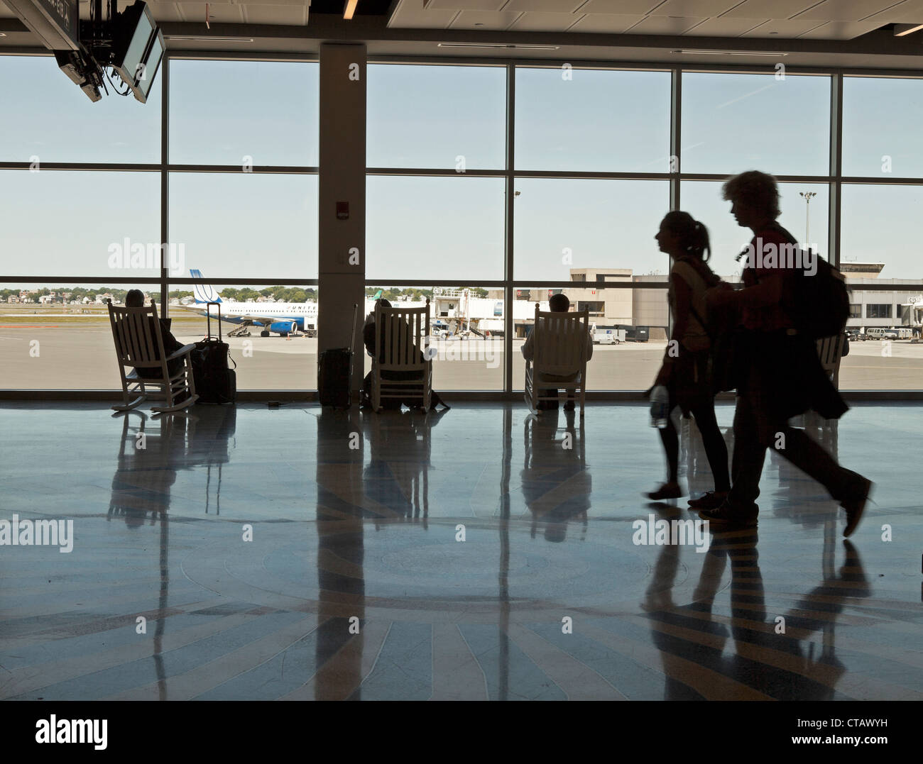 Rocking chairs are provided for passengers at Logan Airport in Boston. Stock Photo