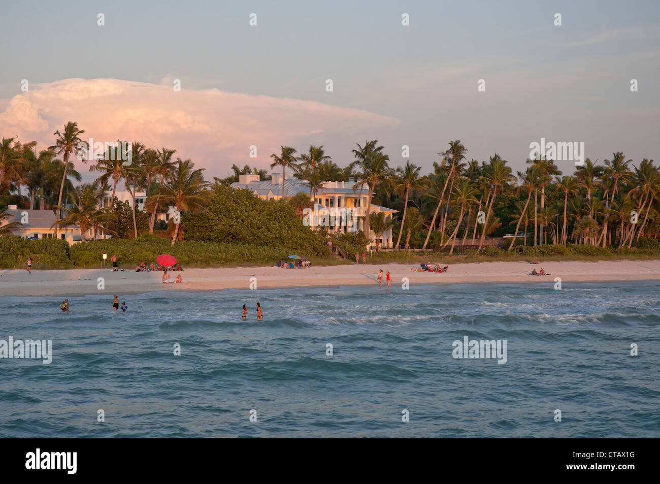 Sunset light bathes the Naples Florida Municipal Beach along the Gulf of Mexico. Stock Photo