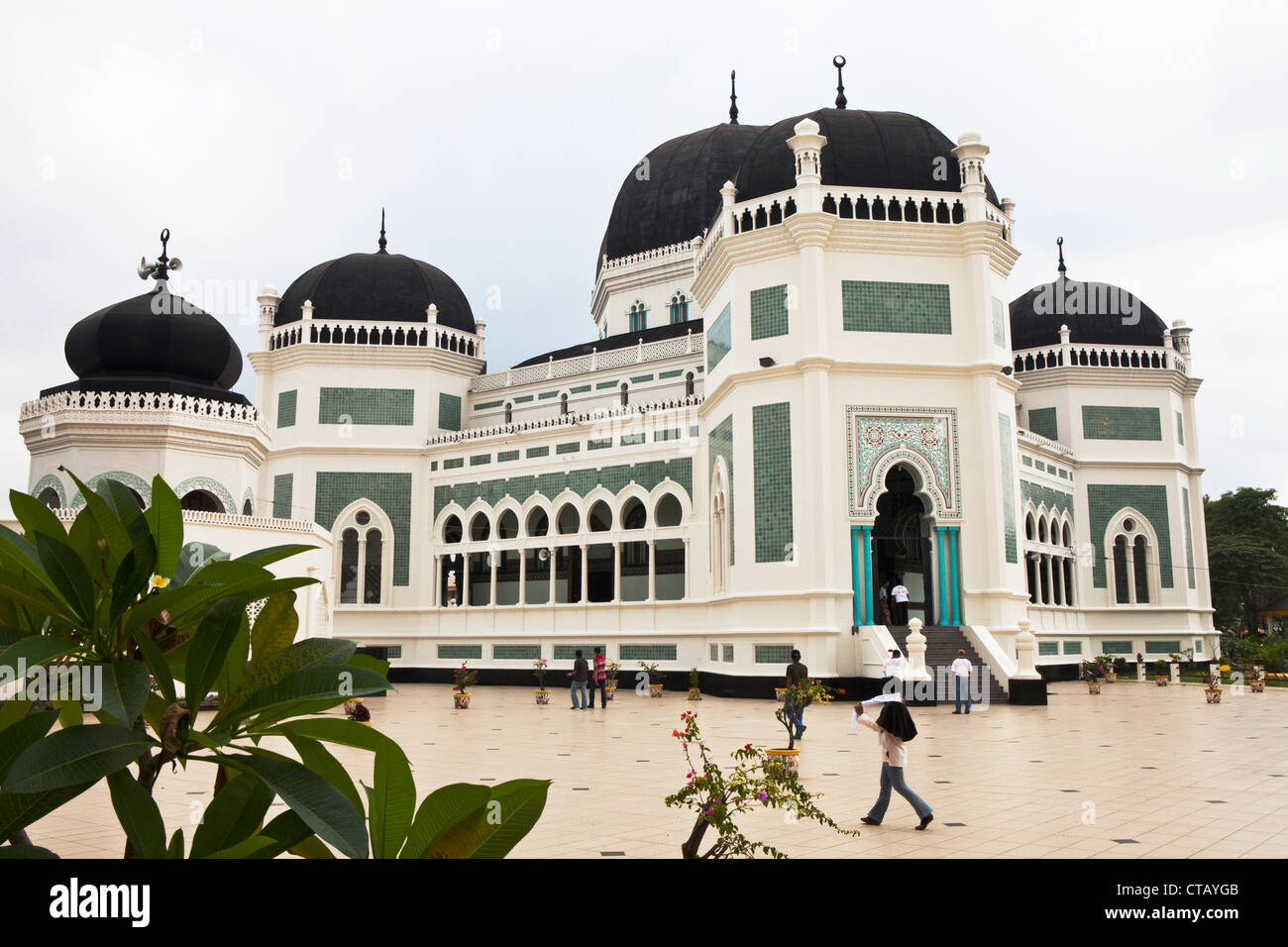 Muslims in front oft he Grand Mosque in Medan, capital of Sumatra Utara province, Island of Sumatra, Indonesia, Southeast Asia Stock Photo