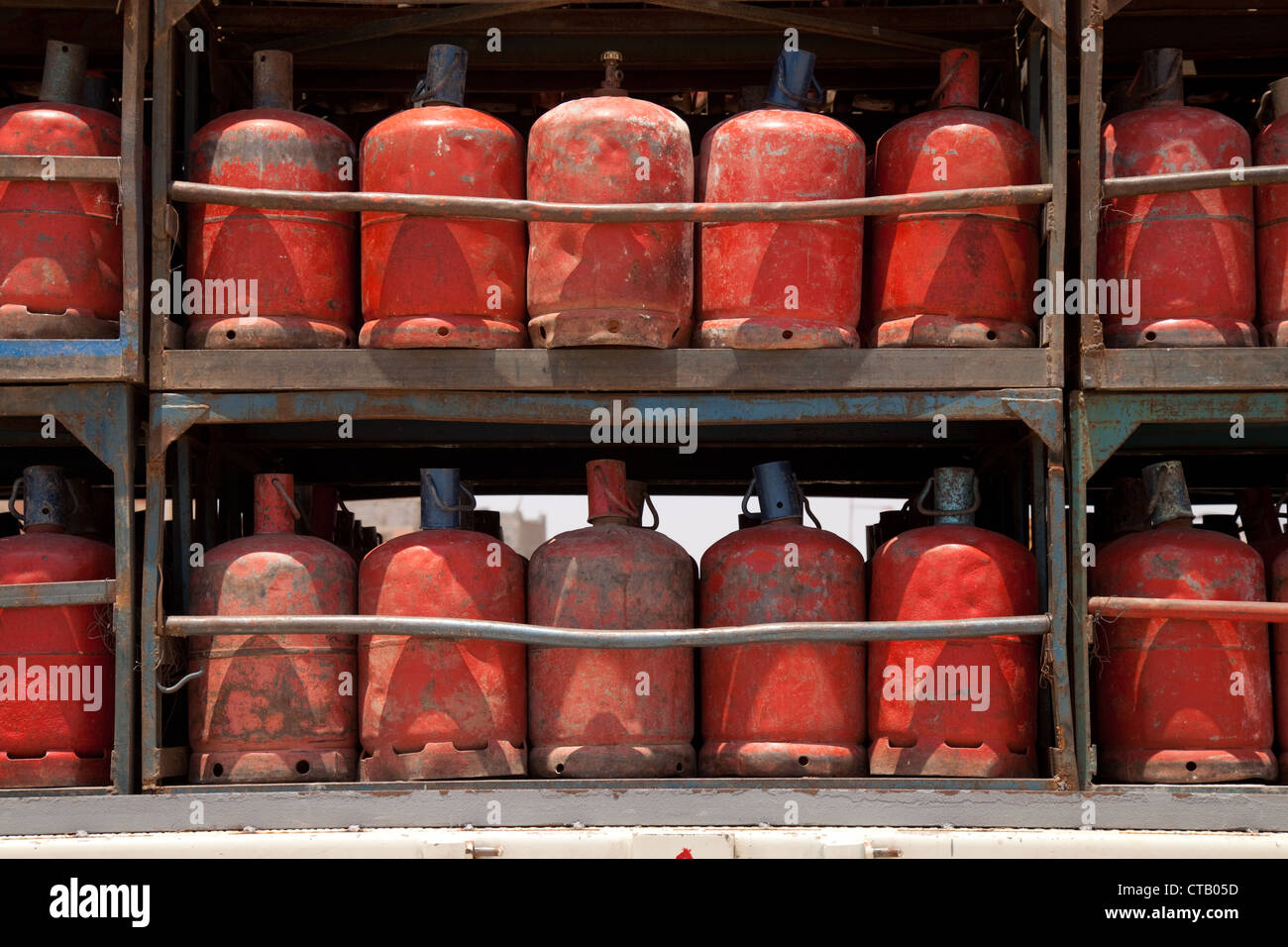 Red propane bottled gas cylinders, Morocco Africa Stock Photo