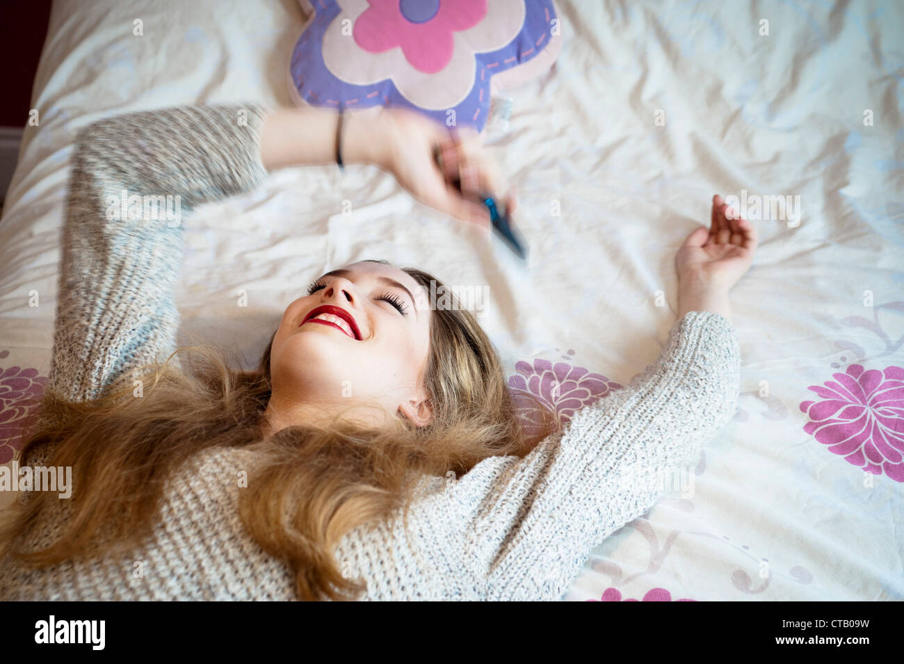 Young 15 Year Old Blond Girl In Teenage Bedroom Holding Her