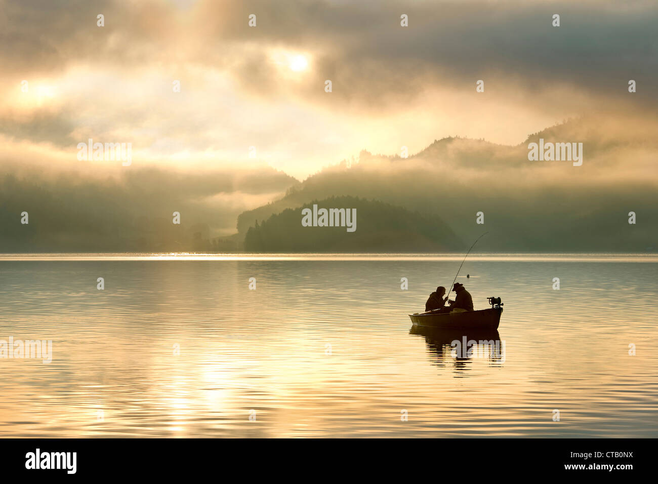 Two angler in a boat on lake Walchen in the morning, Upper Bavaria, Germany Stock Photo