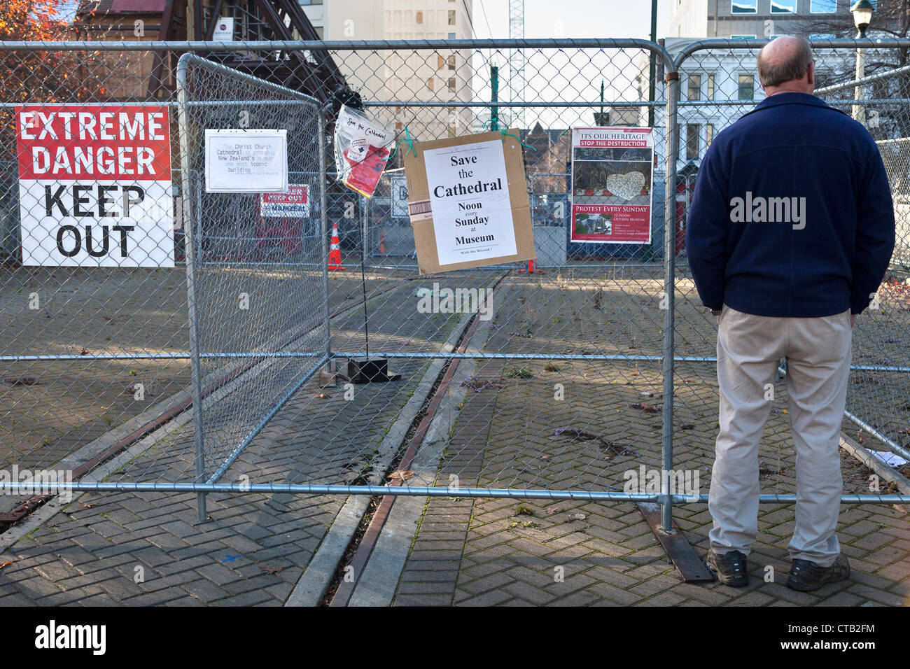 Post-quake Christchurch, New Zealand - man looking into the Red Zone 2 Stock Photo