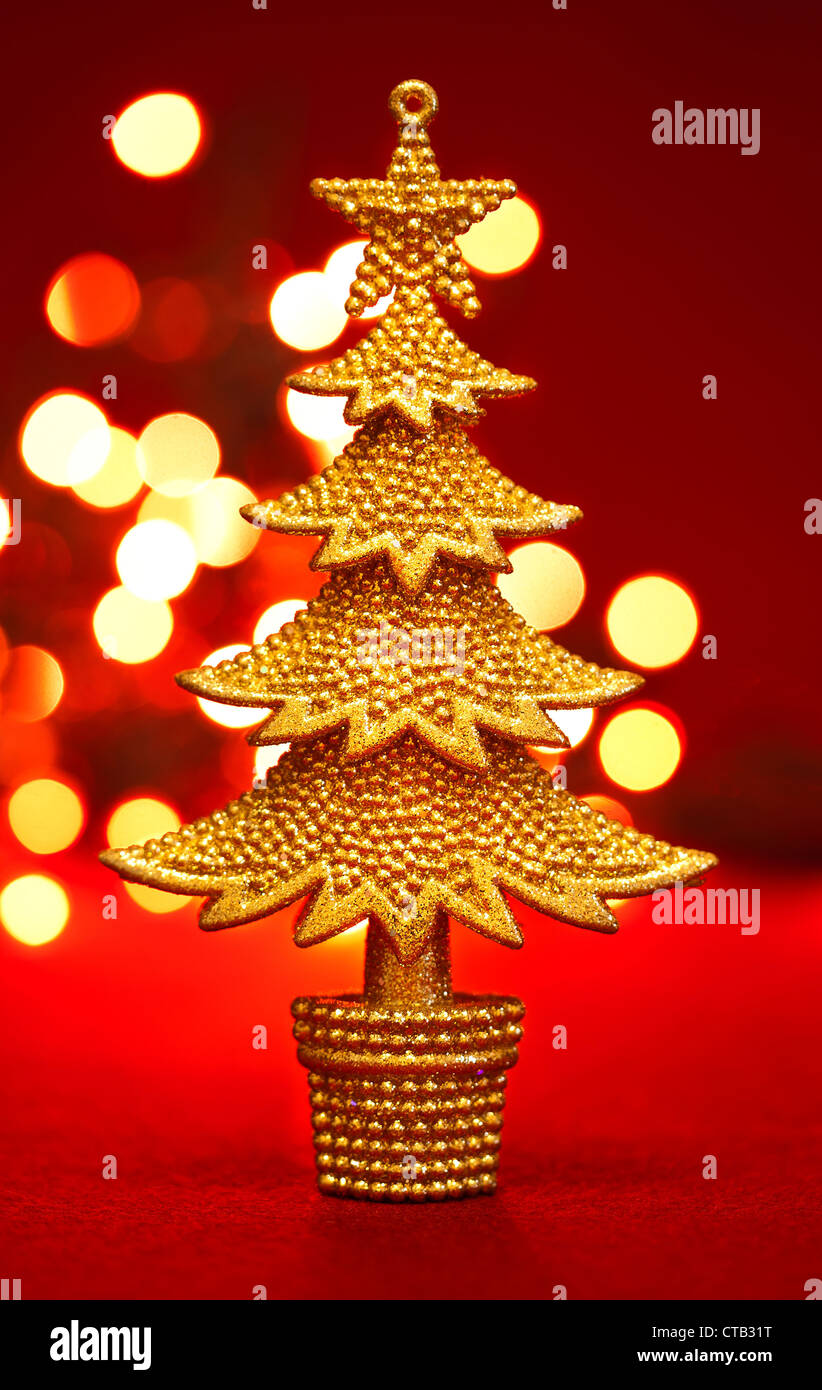Gold christmas tree on the red background Stock Photo - Alamy
