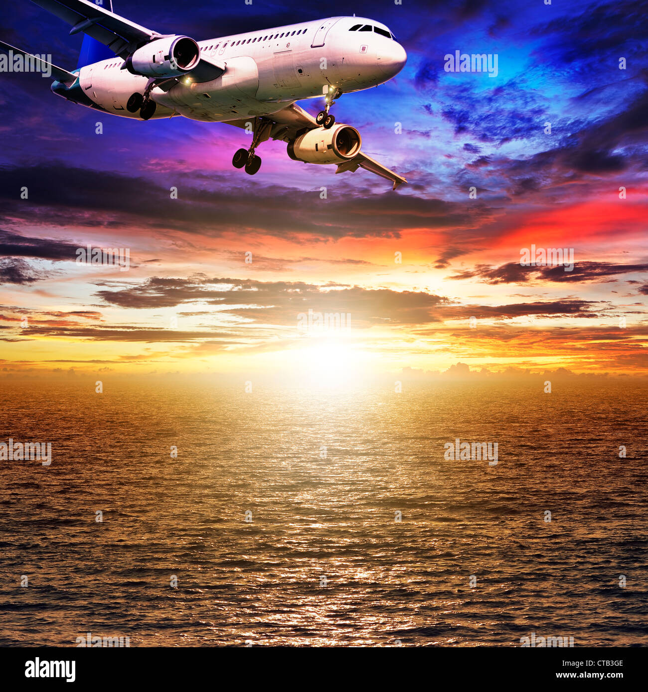 Jet plane over the sea at sunset time. Square composition. Stock Photo